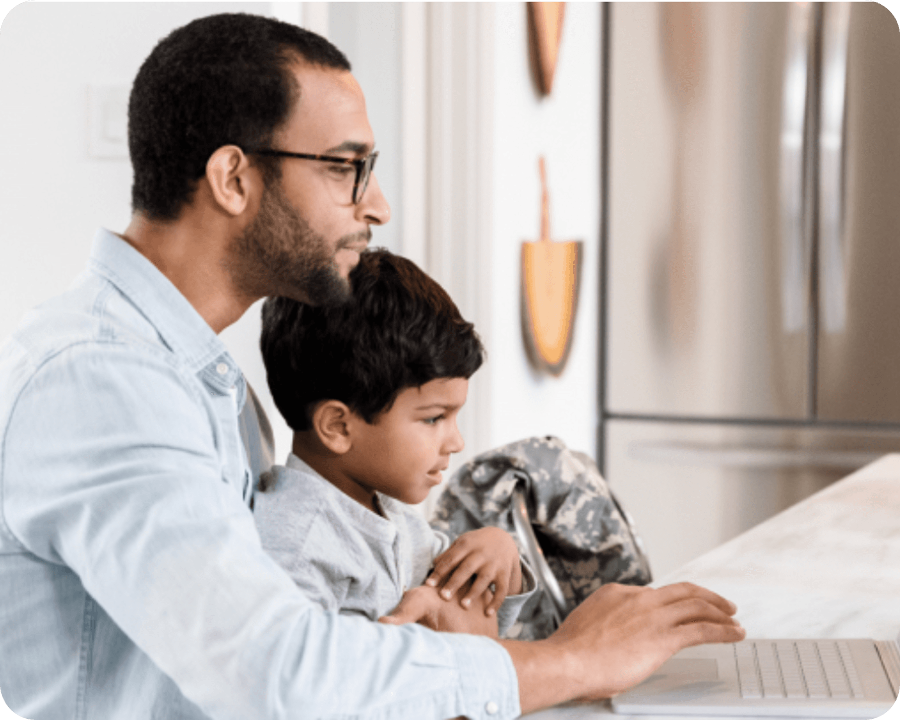 Father and child looking at a laptop together